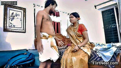 Indian couple in saree and dhoti sharing intimate moment on bed