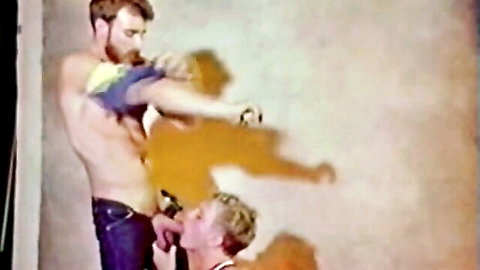 Vintage 1983 gay porn: bearded muscular man getting oral from blond twink in jeans