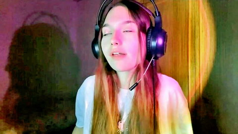 Cute young camgirl Vergiezaic on Chaturbate, teen redhead with headphones