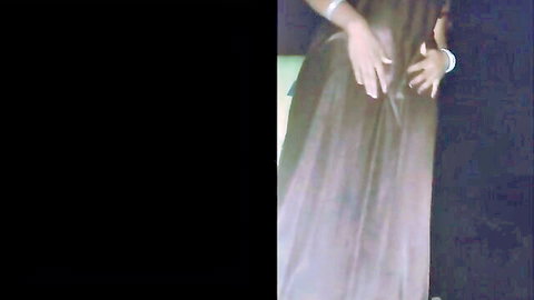 Curvy ebony step sister in flowing dark dress, teasing from behind