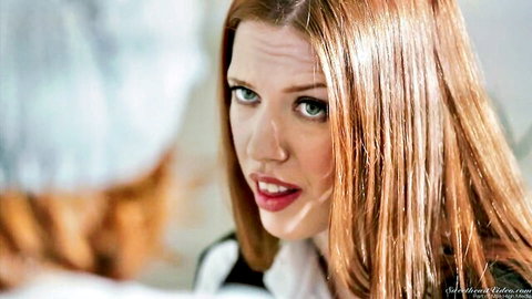 Seductive pale redhead with green eyes and red lips pouting intensely in close-up