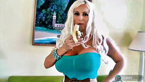 Dolly Delight big natural boobs in turquoise tube top holding banana seductively