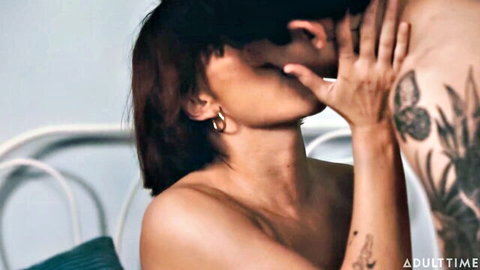 Kell Fire kissing tattooed man passionately topless in bed