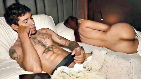 Tattooed muscular man with curvy redhead nude from behind in bed