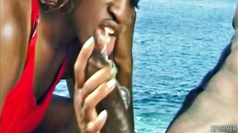 Ebony babe in red bikini slurping huge BBC on sunny beach outdoors