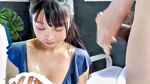 Asian beauty in blue top wiping cumshot with towel