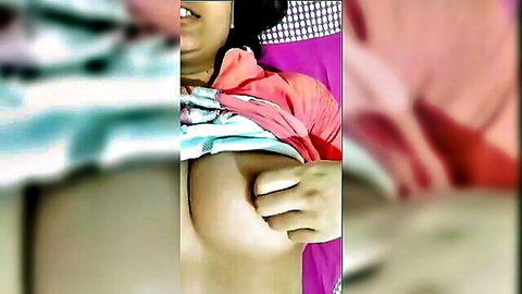 Indian girlfriend smiles as boyfriend's hand squeezes her big bare tits