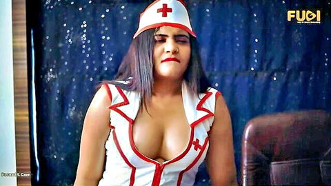 Sexy Indian nurse in low-cut uniform teasing with deep cleavage