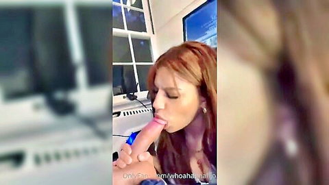 Redhead performing intense blowjob on blue dildo close-up