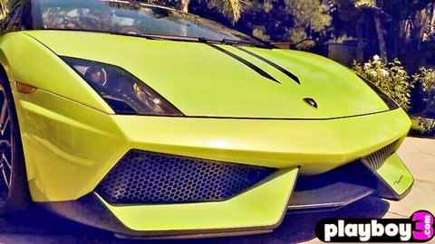 Bright yellow Lamborghini sports car front view parked outdoors with Playboy watermark
