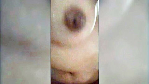 Blurry Korean amateur nude close-up of woman's medium breasts and navel
