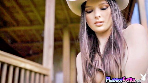 Skinny cowgirl revealing perfect breasts in cowboy hat