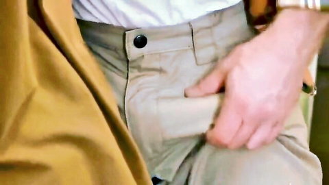Hand gripping thick veiny cock pulled from unzipped khaki pants in gay handjob.