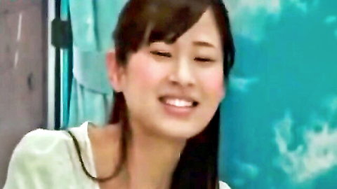 Smiling Japanese woman with brown hair in light green top, indoor tease