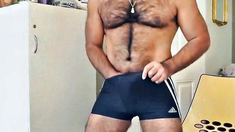 Hairy Asian man in tight Adidas speedos, muscular chest and bulge tease