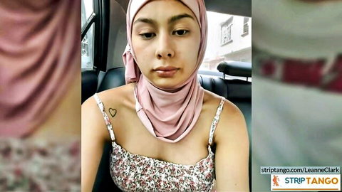 Leanne Clark in pink hijab and floral tank top, teasing in car