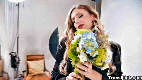 Blonde trans woman with big natural tits smelling blue hydrangea bouquet teasingly