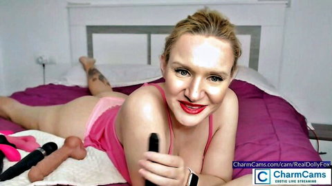 RealDollyFox blonde in pink lingerie teasing with sex toys on cam