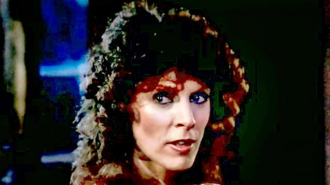 Vintage redhead with frizzy fur-trimmed hair and open mouth in retro closeup