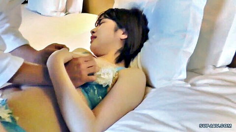 Asian woman in blue lingerie touched intimately by man on bed
