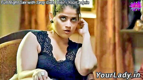 Surprised busty Indian MILF in revealing black lace top showing deep cleavage