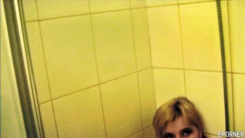 Blonde woman washing natural tits in steamy shower