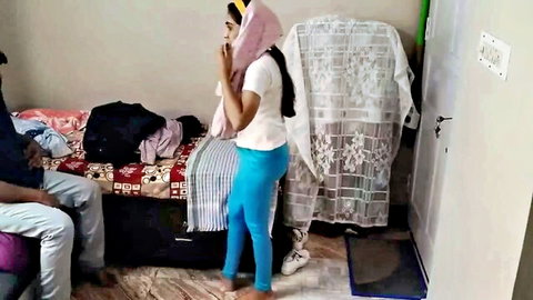 Cute Indian girl in white top and blue leggings chatting on phone seductively