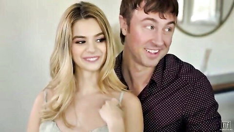Smiling blonde girlfriend with cleavage teases in low-cut top beside happy boyfriend