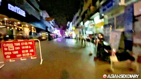 Nighttime Bangkok street scene from AsianSexDiary Pop2, neon lights and closed bar