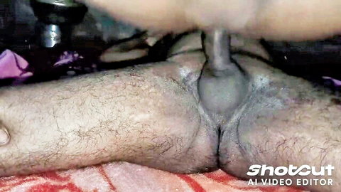 Close-up of hairy man's flaccid penis and balls on pink towel, amateur style