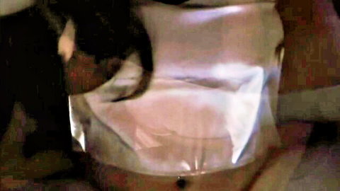 Closeup of pink wet pussy lips through crinkled shiny plastic sheet