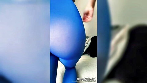 Curvy babe in shiny blue pantyhose bends over as hand grabs her fat juicy ass