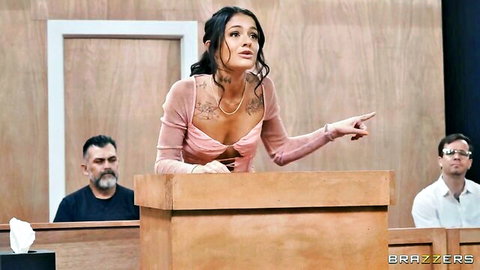 Ryan Reid in revealing pink top at podium in courtroom scene