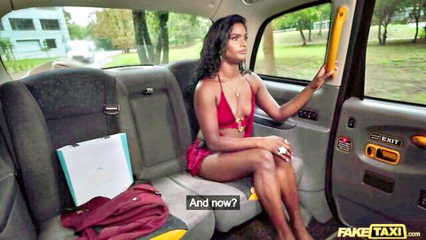 Sexy South Asian babe in skimpy red bikini sits with legs spread in fake taxi backseat