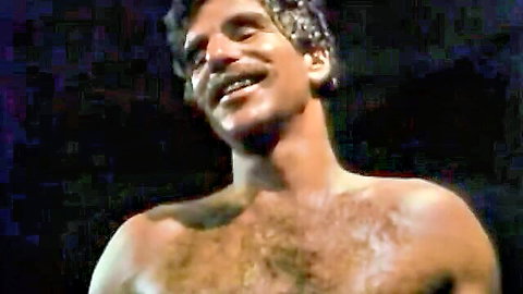 Traci Lords in Educating Mandy: Shirtless hairy man smiling seductively