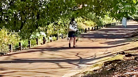 Asian woman in short skirt walking outdoors in park, JAV thumbnail
