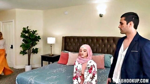 Hijab woman in floral lingerie with suited man and redhead in threesome setup