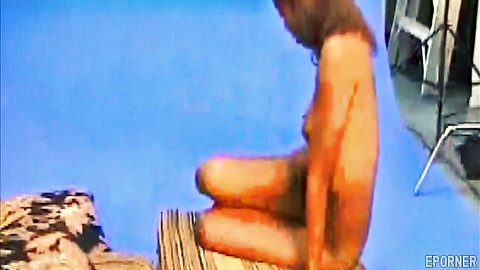 Nina black glamour model nude sitting pose on dock