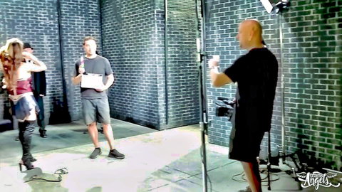 BTS of trans Wonder Woman XXX parody: blonde model in cosplay costume on set with crew