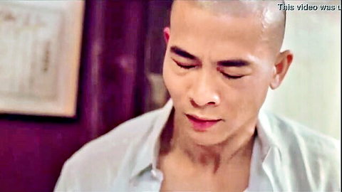 Shaved-head Asian man in open white shirt, intense gaze from Daughter of Darkness 2
