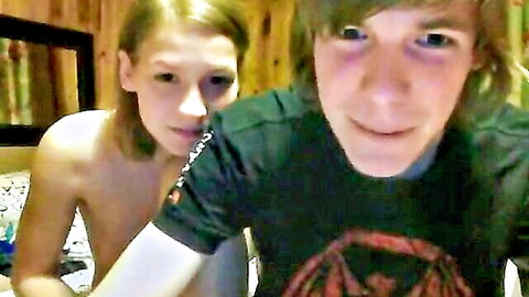 Topless blonde teen girl with small tits smiles close to shaggy-haired stepbrother in bedroom selfie