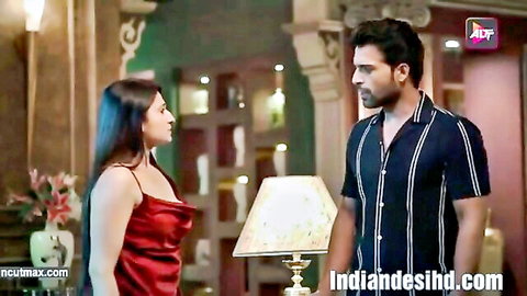 Indian woman in red dress flirts with man in Hindi adult short film