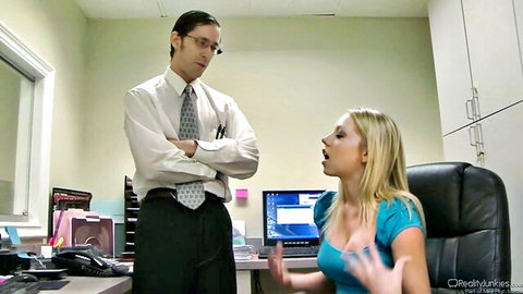 Blonde office woman in cleavage-baring top confronts suited man John Henry