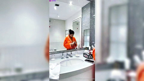 Mia Khalifa preparing in orange outfit for livestream video