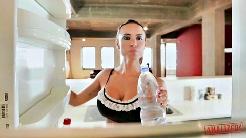 Curvy tanned maid in skimpy black lace bra pours water down her huge cleavage in kitchen