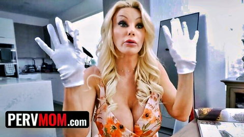 Blonde busty MILF in floral dress and white gloves poses seductively