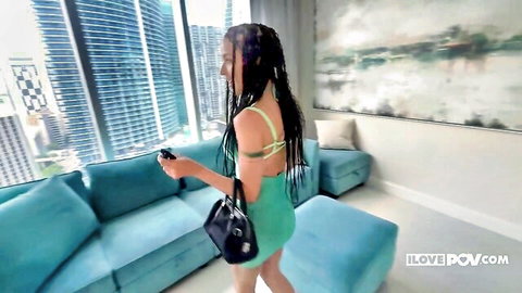 Geisha Kyd in sexy green dress holding game controller, POV tease