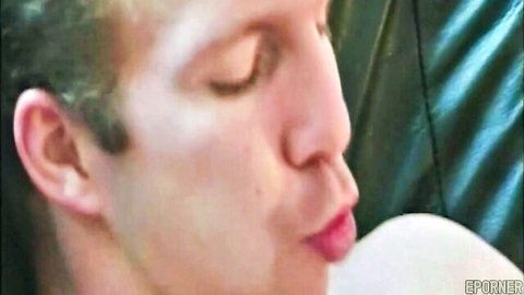 Close-up of handsome blonde teen male with seductive pursed lips in porn video