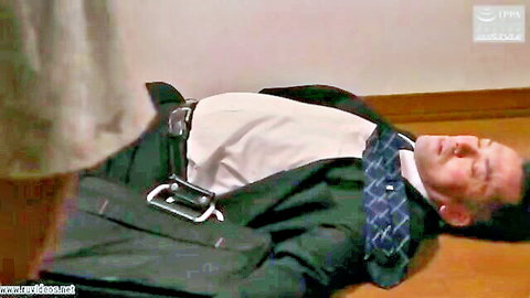 Kaori Iiyama in dress standing over unconscious suited man