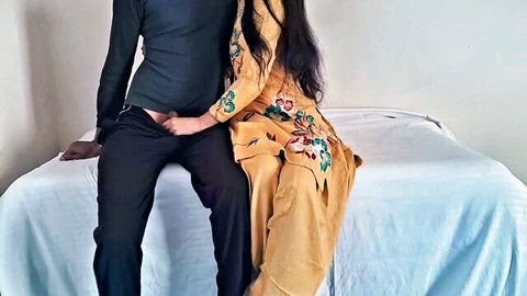 Asian step-sister in embroidered dress cuddles with step-brother on bed in homemade clip